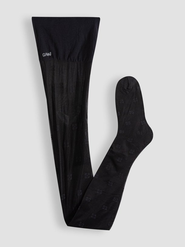 Ontdek de 20 Denier logo panty van Ganni in de kleur zwart bij Orangebag. Op werkdagen voor 21:45 besteld, morgen in huis.