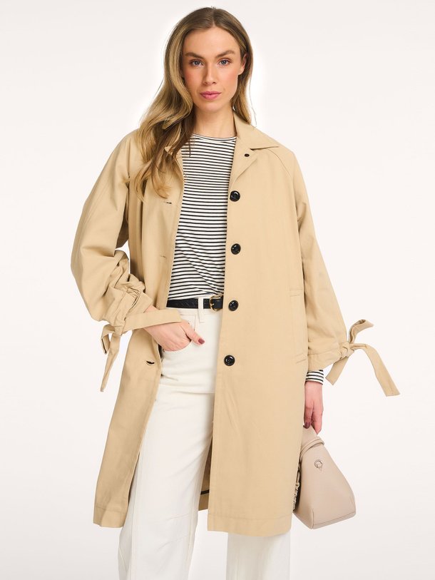 Ontdek de Ieben katoenen trenchcoat van Ruby Tuesday in de kleur Zand bij Orangebag. Op werkdagen voor 21:45 besteld, morgen in huis.