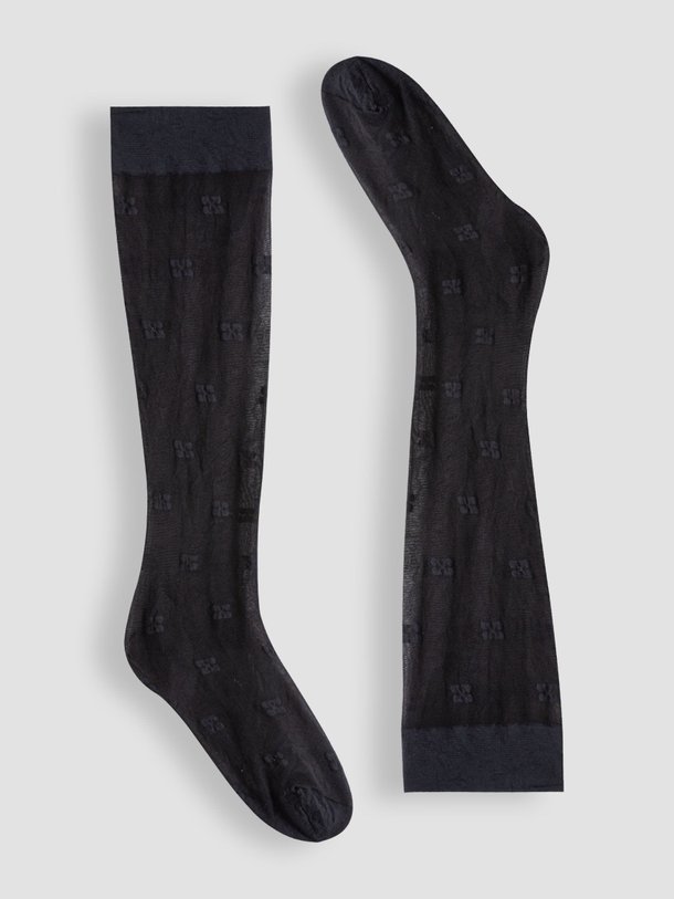 Ontdek de 20 Denier logo sokken van Ganni in de kleur zwart bij Orangebag. Op werkdagen voor 21:45 besteld, morgen in huis.