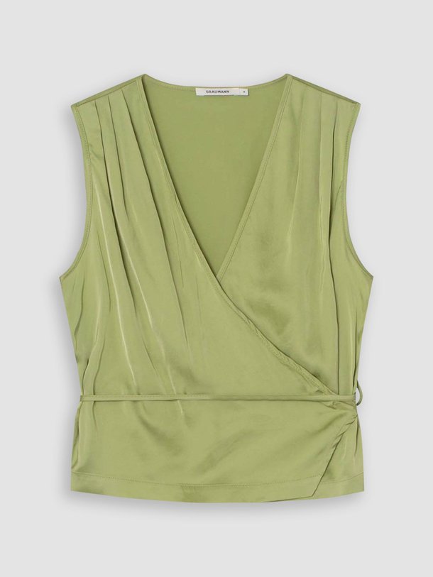 Ontdek de Maja viscosemix glanzende overslagtop van Graumann in de kleur groen bij Orangebag. Op werkdagen voor 21:45 besteld, morgen in huis.